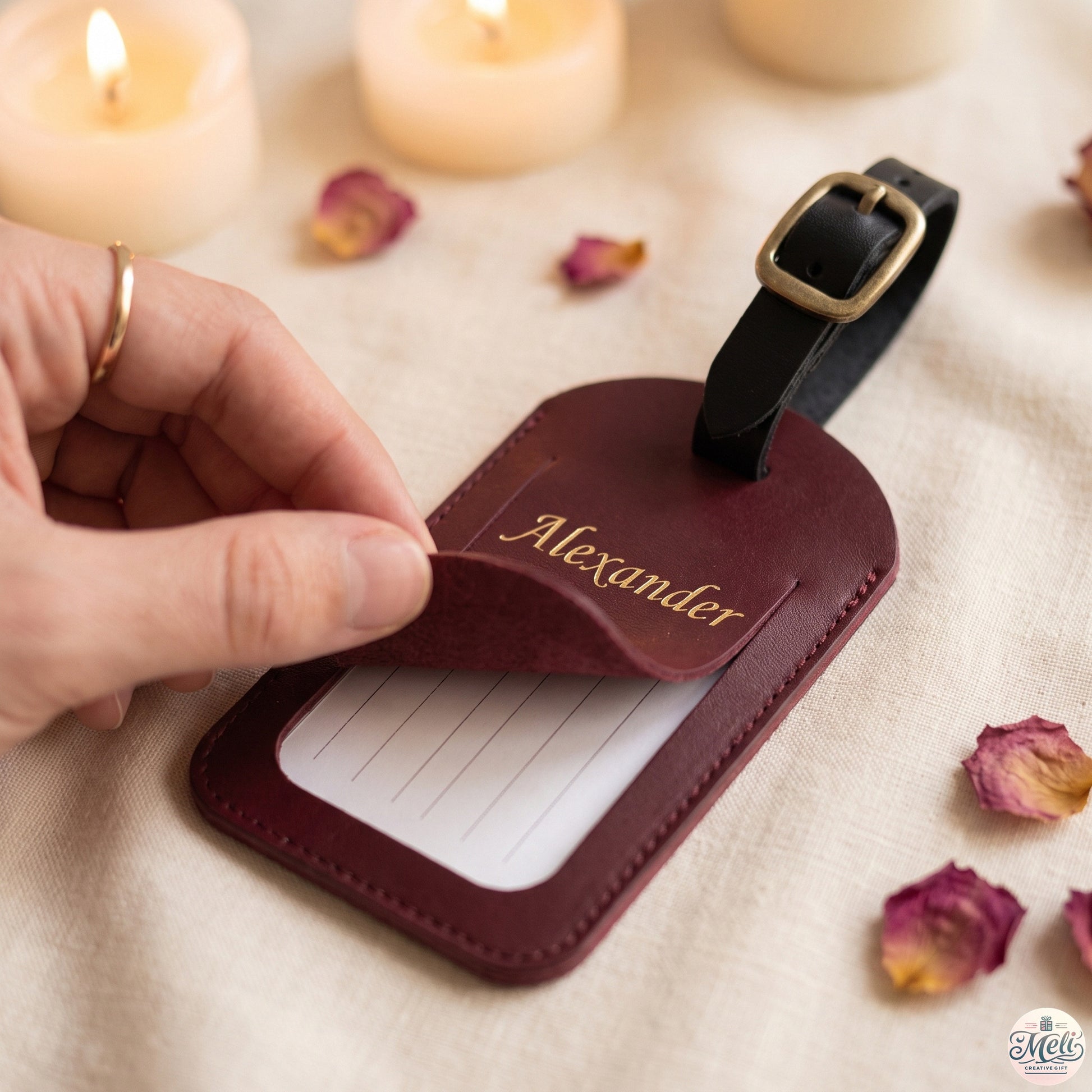 Hand lifting the leather privacy flap to reveal the hidden info card on the tag back